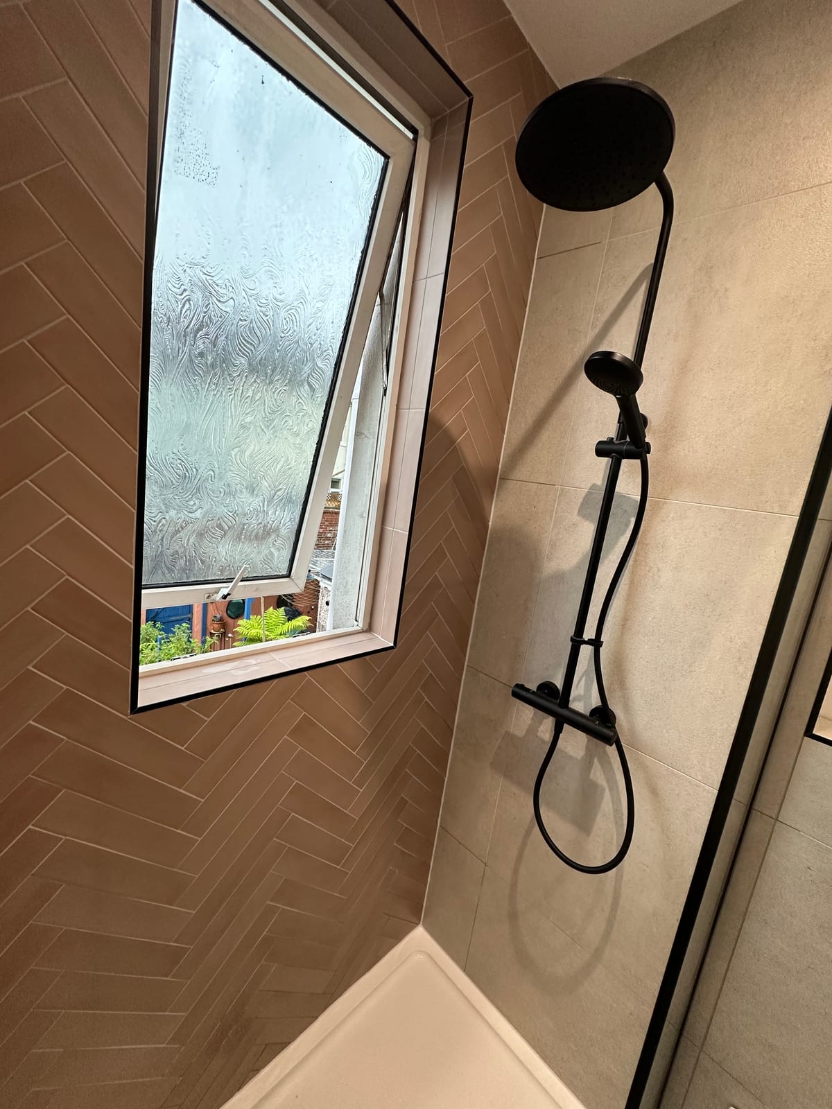 Shower with herringbone tiles and matte black rainfall fittings